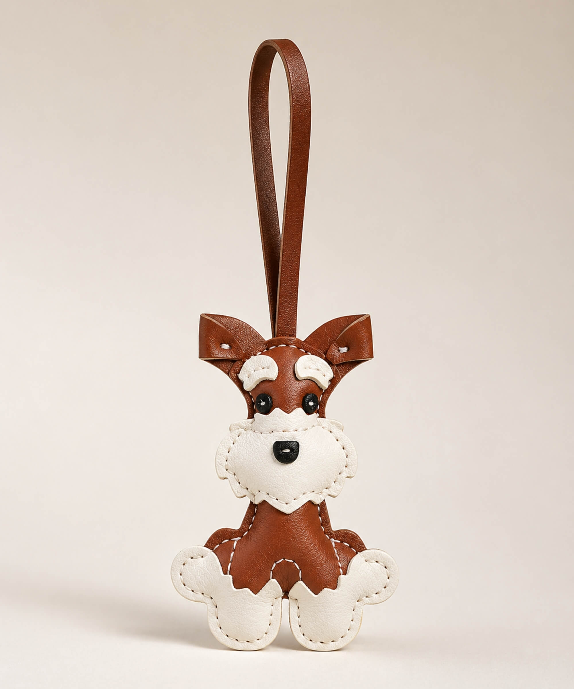 Brown Cute Schnauzer PU leather keychain with matching wrist strap on a soft neutral studio background.